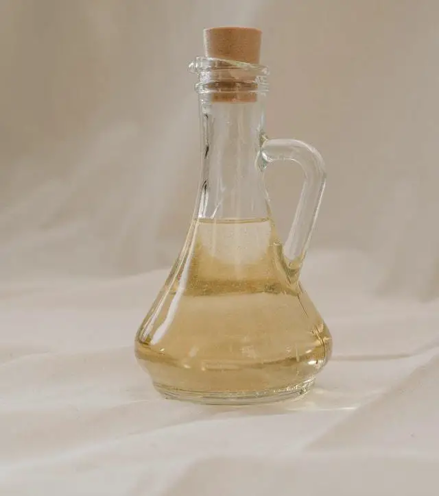 clear glass bottle with coconut oil